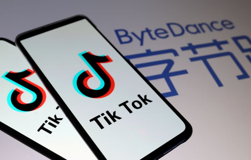 FILE PHOTO: TikTok logos are seen on smartphones in front of displayed ByteDance logo in this illustration