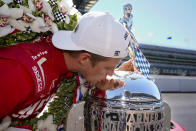 Marcus Ericsson, of Sweden, kisses the Borg-Warner Trophy during the traditional winners photo session at Indianapolis Motor Speedway in Indianapolis, Monday, May 30, 2022. Ericsson won the 106th running of the Indianapolis 500 auto race on Sunday. (AP Photo/Michael Conroy)