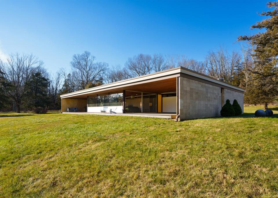 Designed by Philip Collins, the midcentury dwelling is defined by clean lines, sheltered patios, and floor-to-ceiling glazing.
