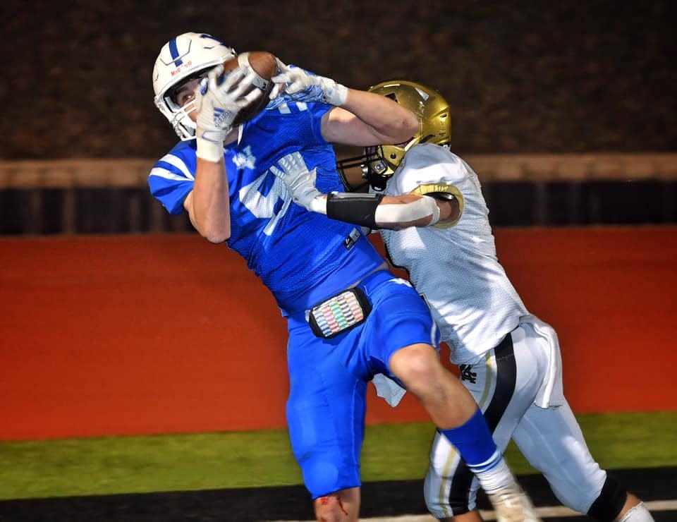 Brayden Berend (5) of Windthorst catches a touchdown pass over Archer City’s McKinnen Beaver in second quarter action Thursday night in Iowa Park.