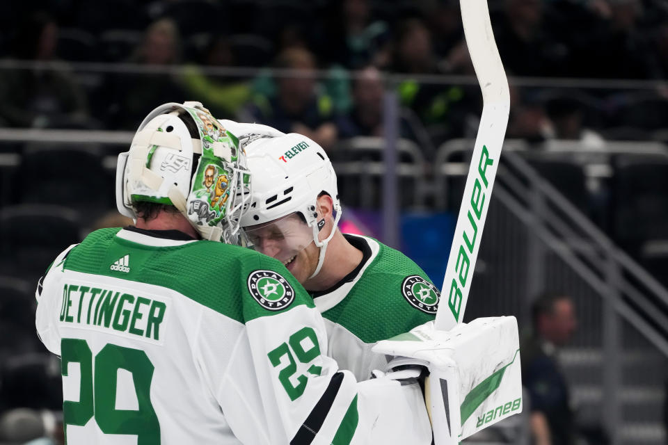 Dallas Stars goaltender Jake Oettinger, left, is greeted by defenseman Esa Lindell after the team's 3-0 win over the Seattle Kraken in an NHL hockey game Saturday, March 30, 2024, in Seattle. (AP Photo/Lindsey Wasson)