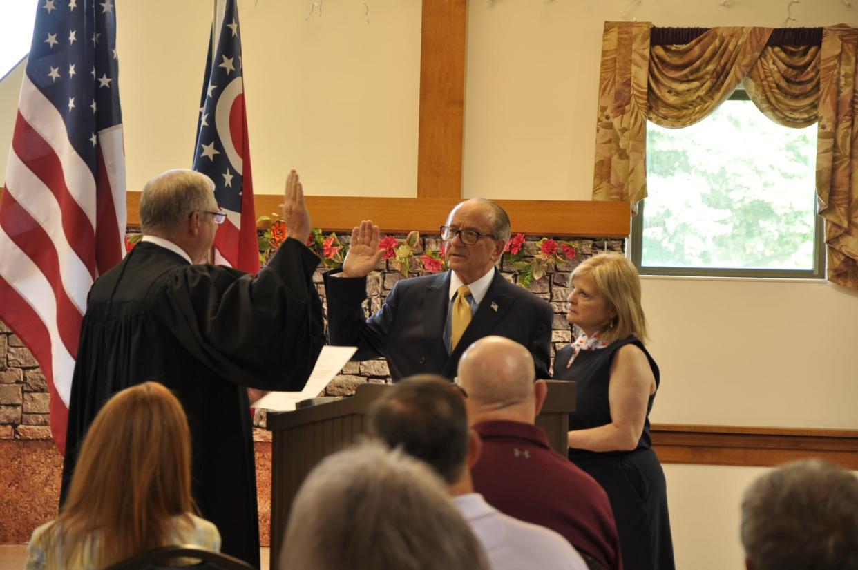 Andrew Grove stands with his wife, Susan, as Alliance Municipal Court Judge Andrew Zumbar swears him in as the 51st mayor of Alliance on Wednesday, Aug. 9, 2023, during a ceremony at Alliance Area Senior Center.