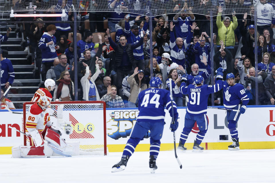 Toronto Maple Leafs right wing William Nylander, right, celebrates his first-period goal against the Calgary Flames during an NHL hockey game Friday, Nov. 10, 2023, in Toronto. (Cole Burston/The Canadian Press via AP)