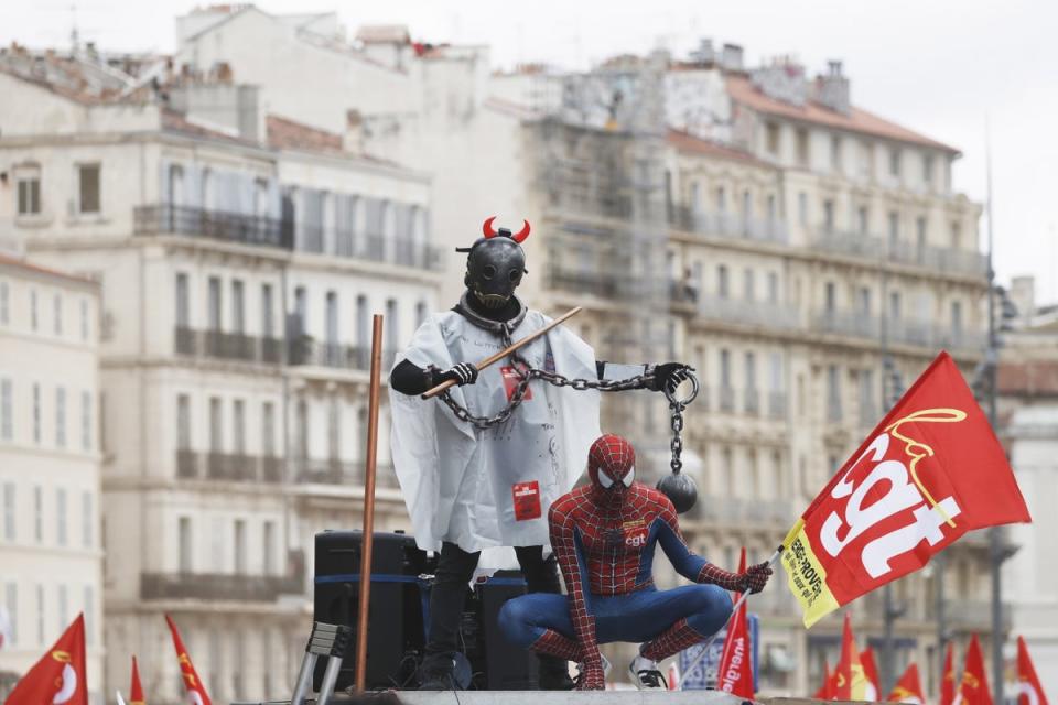 People wear costumes as they ride on a CGT union truck during a rally against the government’s pension reform (EPA)