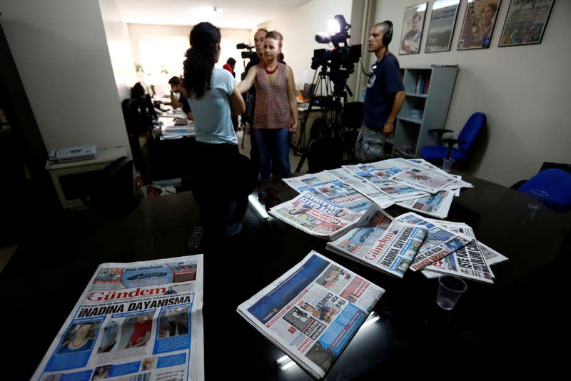 FILE PHOTO: A journalist of pro-Kurdish Ozgur Gundem gives an interview to a German TV channel at their newsroom before a protest against the arrest of three prominent campaigners for press freedom, in front of the pro-Kurdish Ozgur Gundem newspaper in Ist