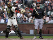 Miami Marlins' Jon Berti, right, reacts next to San Francisco Giants catcher Patrick Bailey, left, after being called out on strikes during the fifth inning of a baseball game in San Francisco, Saturday, May 20, 2023. (AP Photo/Godofredo A. Vásquez)