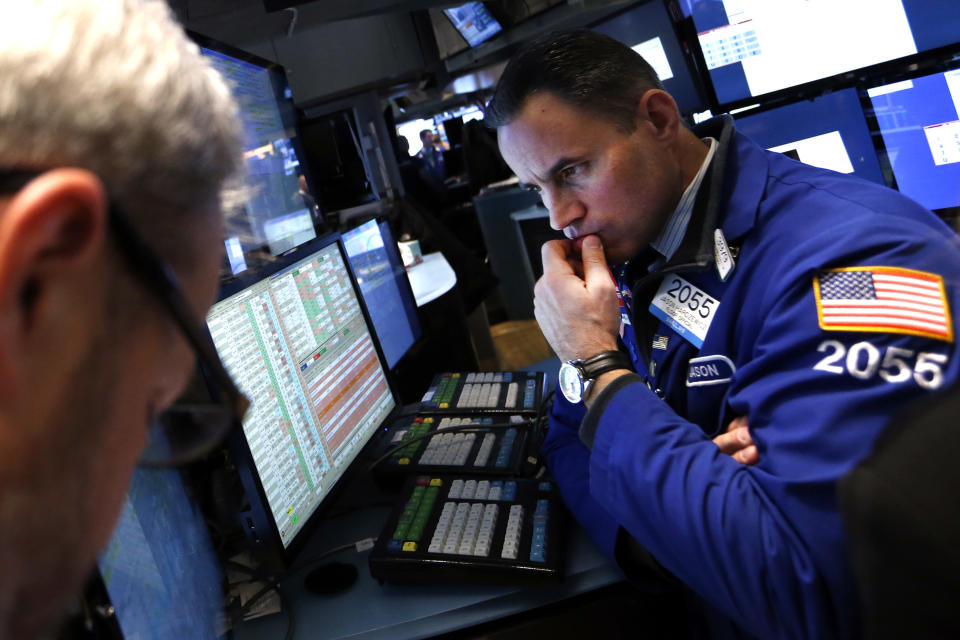 FILE - In this Friday, Jan. 24, 2014, file photo, specialist Jason Hardzewicz works on the floor of the New York Stock Exchange. Global stocks continued to fall on Monday, Jan. 27, 2014, extending a rout begun last week, as investors worried about a slowdown in growth in China and other developing economies that is causing big losses among emerging-market currencies. (AP Photo/Jason DeCrow, File)