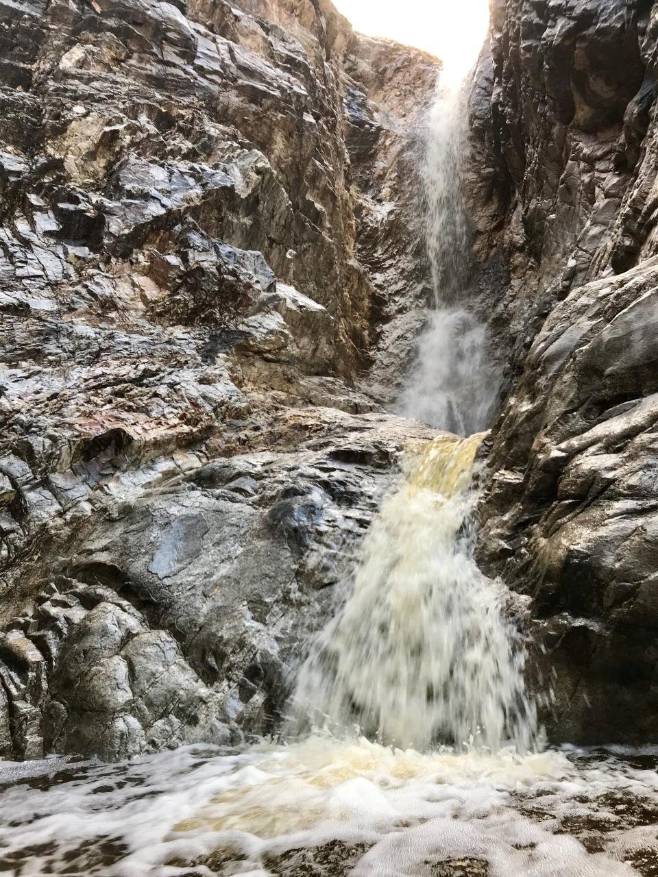 The Waterfall Trail at White Tank Mountain Regional Park leads to a gash in a cliff face that cascades with water after heavy rains. At other times, it's dry.