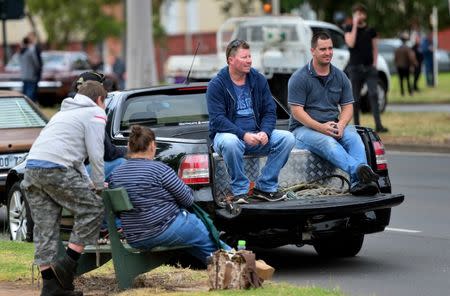 Former Holden employees sit on the back of their Holden ute outside the Holden plant in Elizabeth, South Australia, October 20, 2017 as supporters of the Australian-made cars mark the final Commodore vehicle to officially roll off the production line today. AAP/Mark Brake/via REUTERS.