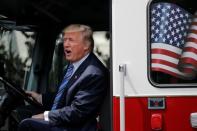 U.S. President Donald Trump sits on a firefighter truck as he participates in a "Made in America" products showcase at the White House in Washington, U.S., July 17, 2017. REUTERS/Carlos Barria