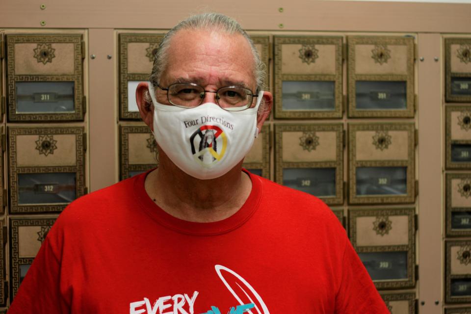 OJ Semans, the co-director of a Native American voter advocacy group, poses in the post office in Mission, South Dakota on Aug. 6, 2020. Semans shares a post office box with members of his extended family and says that a reliance in mail-in voting makes it difficult for Native Americans to cast their ballot. (AP Photo/Stephen Groves)