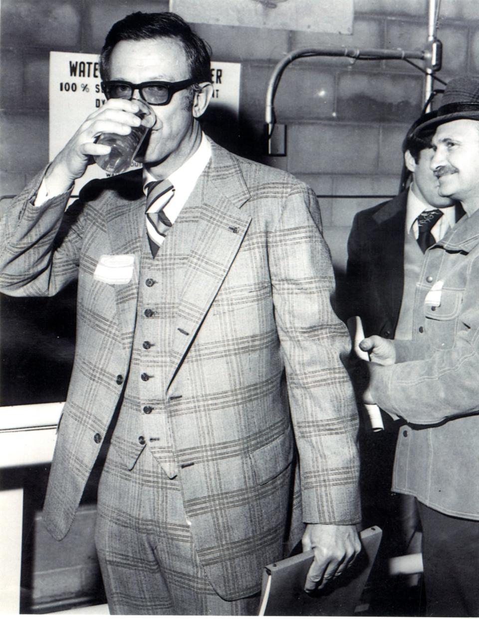 George W. Mead II drinking treated effluent from the new Consolidated Water Renewal Center in Whiting at the dedication of the facility Oct. 5, 1977.