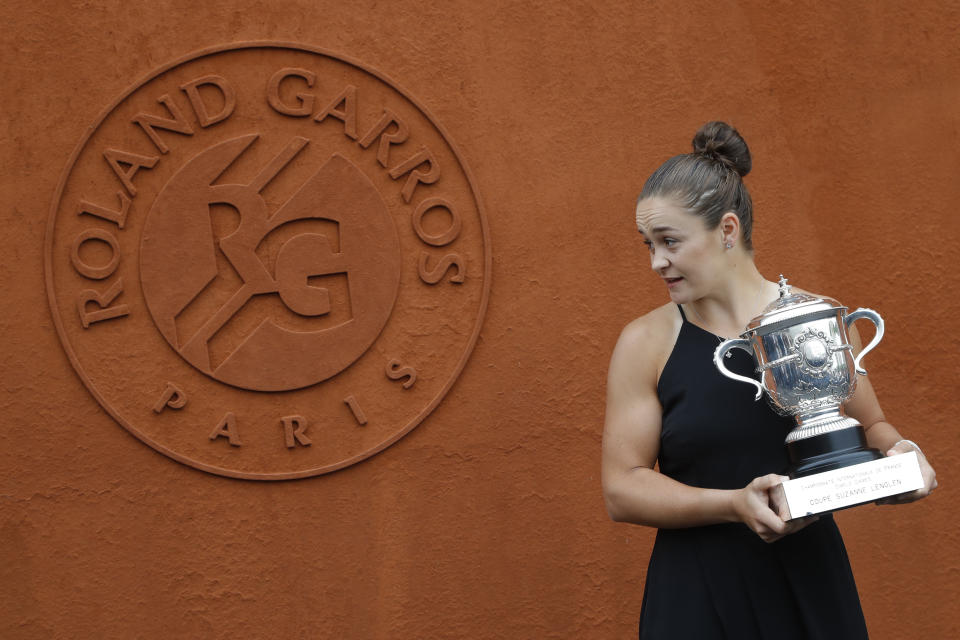 Australia's Ashleigh Barty poses with the trophy during a photo call at the Roland Garros stadium in Paris, Sunday, June 9, 2019. Barty won the French Open tennis tournament women's final on Saturday June 8, 2019. (AP Photo/Michel Euler)
