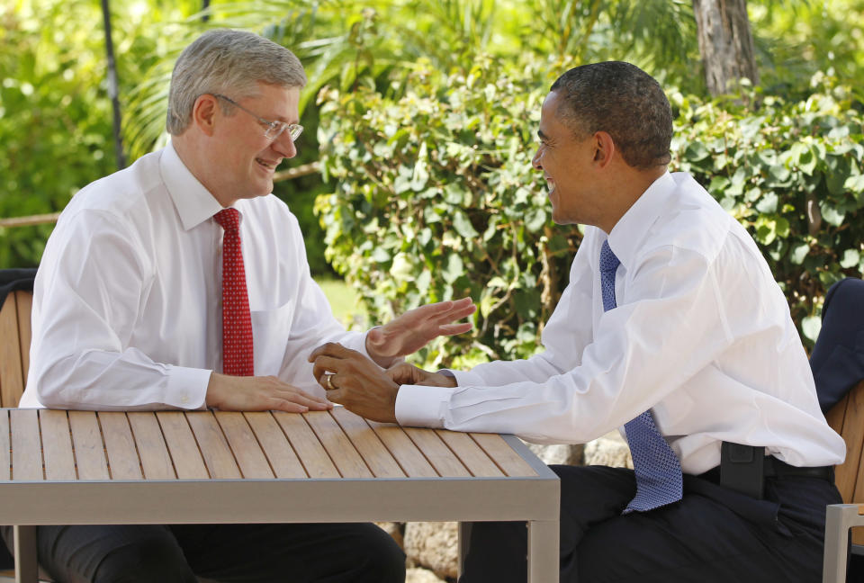FILE - In this Nov. 13, 2011, file photo, Canadian Prime Minister Stephen Harper, left, talks with U.S. President Barack Obama following the first plenary session of the Asia-Pacific Economic Cooperation summit in Kapolei, Hawaii. Obama is convening a summit with leaders from Mexico and Canada on Monday, April 2, 2012, that aims to boost a fragile recovery and grapple with thorny energy issues against a backdrop of painfully high gas prices. The session at the White House is a make-good for a planned meeting last November in Hawaii on the sidelines of the Asia-Pacific summit. Obama ended up meeting just with Harper when Mexican President Felipe Calderon's top deputy was killed in a helicopter crash. (AP Photo/Charles Dharapak, File)