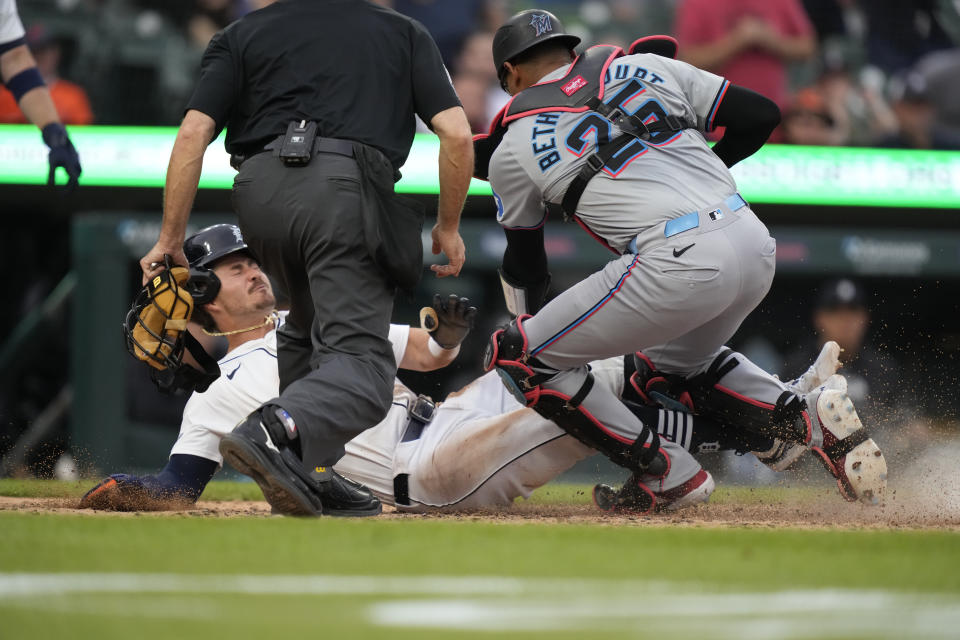 Detroit Tigers' Zach McKinstry is tagged out by Miami Marlins catcher Christian Bethancourt at home plate during the fourth inning of a baseball game, Monday, May 13, 2024, in Detroit. (AP Photo/Carlos Osorio)