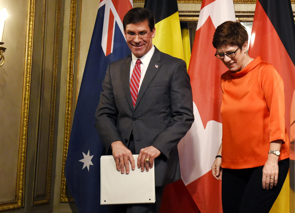 U.S. Secretary for Defense Mark Esper, left, and German defense minister Annegret Kramp-Karrenbauer leave the stage after a press conference on the first day of the Munich Security Conference in Munich, Germany, Friday, Feb. 14, 2020. (AP Photo/Jens Meyer)b