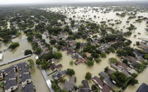 <p>Water from Addicks Reservoir flows into neighborhoods as floodwaters from Tropical Storm Harvey rise Tuesday, Aug. 29, 2017, in Houston. (Photo: David J. Phillip/AP) </p>