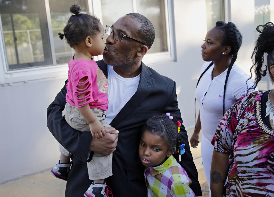 FILE - Anthony Wright gets a kiss from his granddaughter Romera Wright, 1, and holds on tight to his other granddaughter, Daria Wright, 8, while spending time with his family after walking out of Curran Fromhold Correctional Facility a free man on Aug. 23, 2016, in Philadelphia. A jury on Tuesday, Jan. 30, 2024, found Wright not guilty in his retrial in the rape and murder of a 77-year-old woman a quarter-century ago, after DNA evidence pointed to another man. (Michael Bryant/The Philadelphia Inquirer via AP, File)