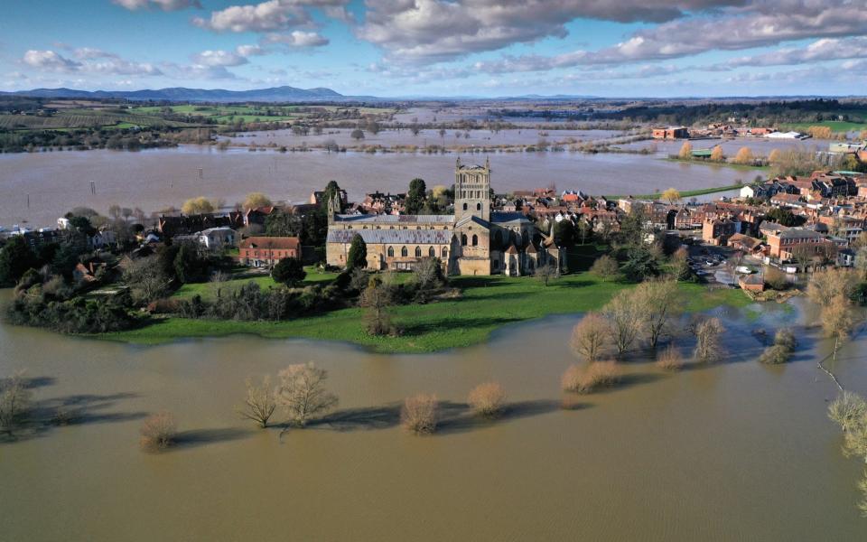 Tewkesbury Abbey, at the confluence of the Rivers Severn and Avon, is surrounded by flood waters  - Getty