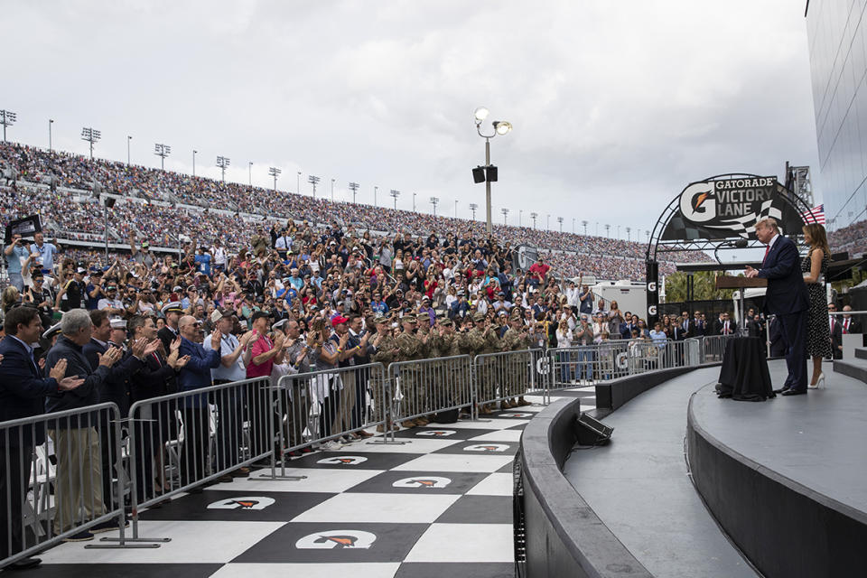 President Donald Trump, accompanied by first lady Melania Trump, speaks before the start of the NASCAR Daytona 500 auto race at Daytona International Speedway, Sunday, Feb. 16, 2020, in Daytona Beach, Fla. (AP Photo/Alex Brandon)