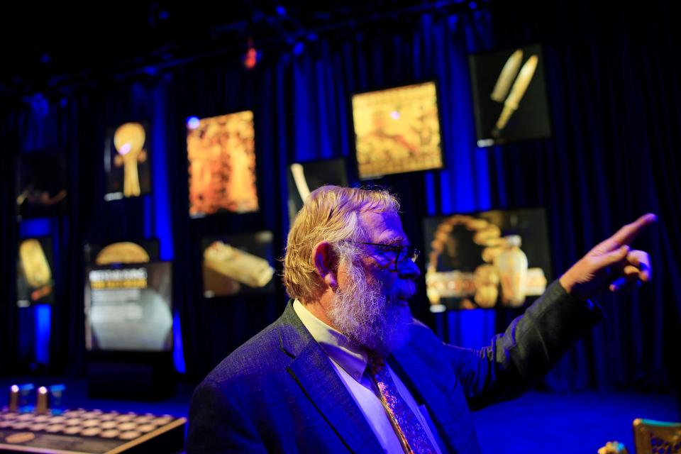 Freelance photographer Ken Garrett points some of more than 200 photos he took for National Geographic included in "Beyond King Tut: The Immersive Experience," the new show opening at NoCo Center in downtown Jacksonville.