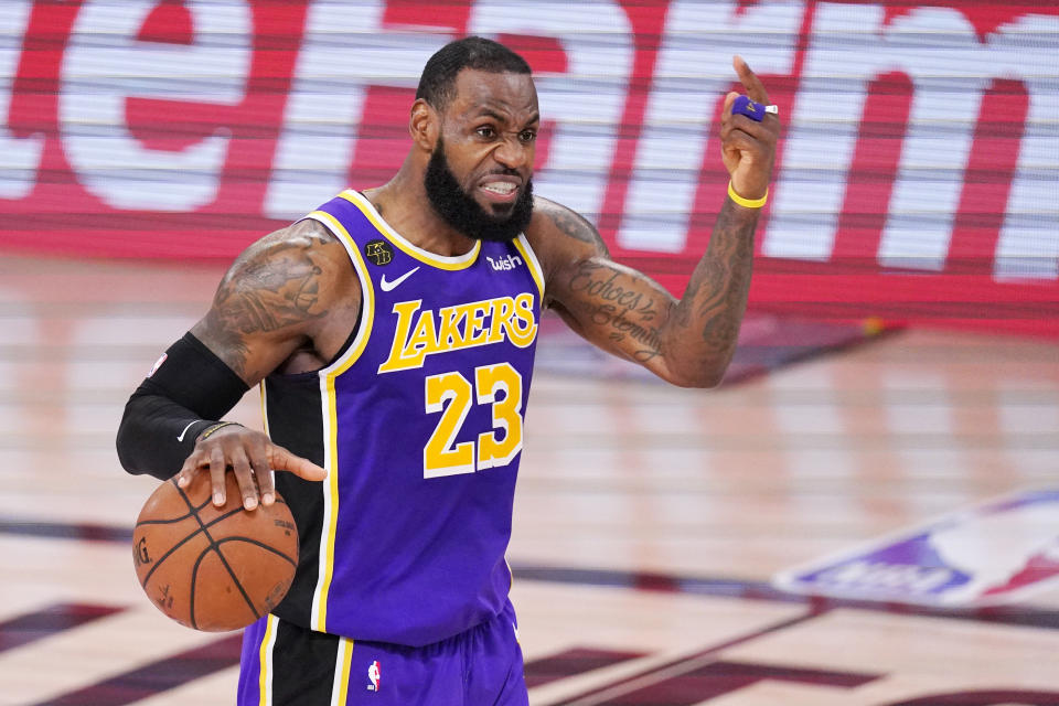 Los Angeles Lakers' LeBron James directs a play against the Denver Nuggets during the second half of an NBA conference final playoff basketball game Saturday, Sept. 26, 2020, in Lake Buena Vista, Fla. (AP Photo/Mark J. Terrill)