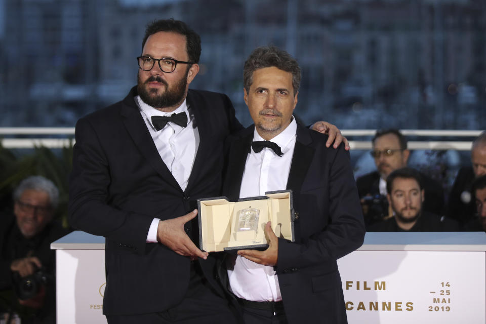 Directors Juliano Dornelles, left and Kleber Mendonca Filho, co-winners of the jury prize for the film 'Bacurau' pose for photographers during a photo call following the awards ceremony at the 72nd international film festival, Cannes, southern France, Saturday, May 25, 2019. (AP Photo/Petros Giannakouris)