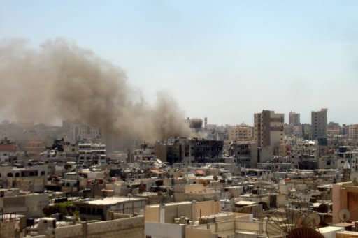 An image from the Syrian opposition's Shaam News Network on July 5 shows smoke rising from a neighbourhood in Homs. AFP cannot independently verify this image