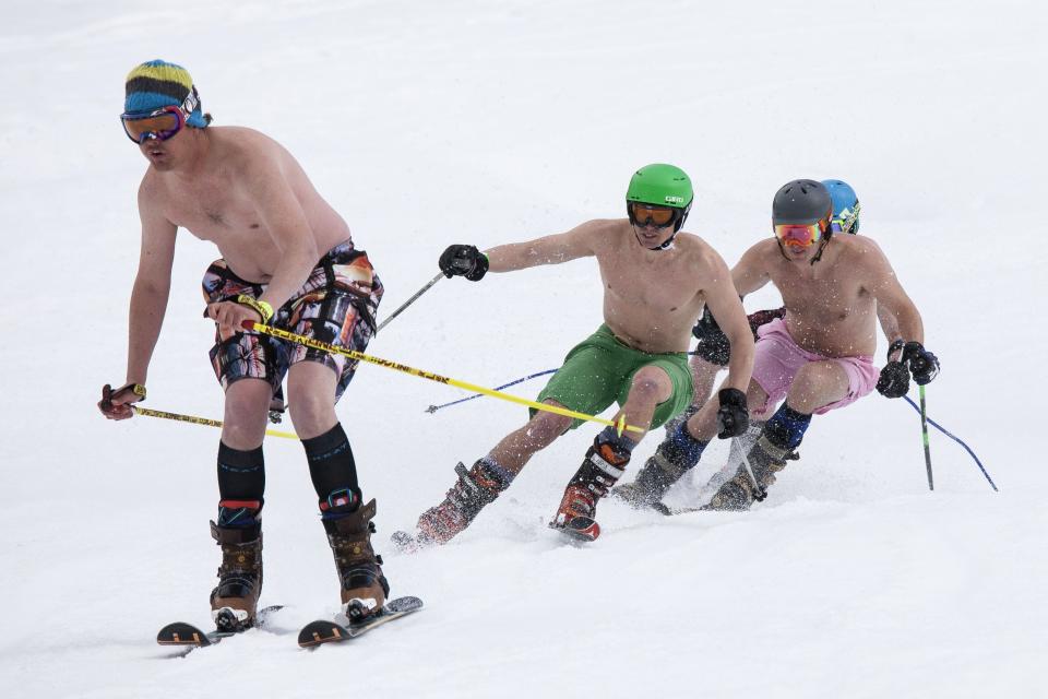 Skiers compete in the Bikini & Board Shorts Downhill at Crystal Mountain, a ski resort near Enumclaw, Washington April 19, 2014. Skiers and snowboarders competed for a chance to win one of four season's passes. REUTERS/David Ryder (UNITED STATES - Tags: SOCIETY SPORT)