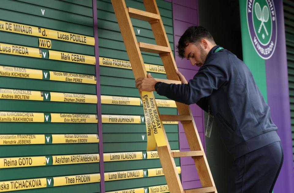 The names of Murray and Raducanu are removed from the order of play board (Getty)