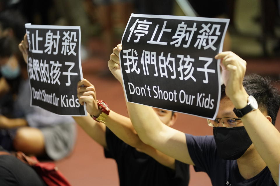 Residents of Tsuen Wan gather at an open air stadium to protest a teenage demonstrator shot at close range in the chest by a police officer in Hong Kong, Wednesday, Oct. 2, 2019. Hong Kong office workers and schoolmates of the teenage demonstrator rallied Wednesday to condemn police tactics and demand accountability. (AP Photo/Vincent Thian)
