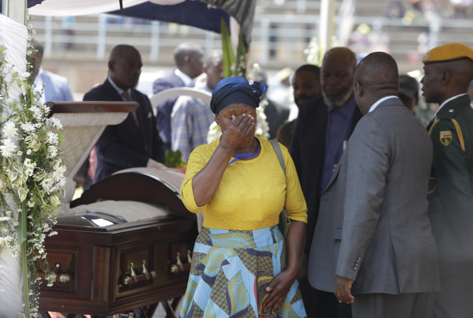 A mourner weeps after viewing the coffin with former Zimbabwean President Robert Mugabe at the Rufaro Stadium in Harare, Friday, Sept. 13, 2019, where the body is on view at the stadium for a second day. Mugabe died last week in Singapore at the age of 95. He led the southern African nation for 37 years before being forced to resign in late 2017. (AP Photo/Themba Hadebe)