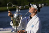 Nelly Korda kisses the trophy while posing for photos after winning the Chevron Championship LPGA golf tournament Sunday, April 21, 2024, at The Club at Carlton Woods in The Woodlands, Texas. (AP Photo/David J. Phillip)