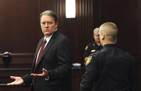 Michael Dunn (L) raises his hands in disbelief as he looks toward his parents after the verdicts were announced in his trial in Jacksonville, Florida February 15, 2014. REUTERS/Bob Mack/Florida Times-Union/Pool