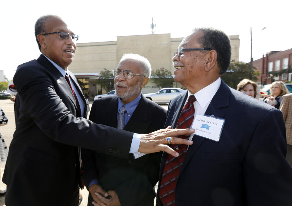 FILE - In this Aug. 17, 2017 file photo Albert Lassiter, left, Meredith C. Anding Jr., center, and Alfred Lee Cook, all members of the "Tougaloo Nine", greet each other prior to the unveiling of the newest Mississippi Freedom Trail marker recognizing them for their peaceful sit-in of the then whites only Jackson Municipal Library in Jackson, Miss. Anding died Friday, Jan. 8, 2021. He was 79. (AP Photo/Rogelio V. Solis) (AP Photo/Rogelio V. Solis, File)