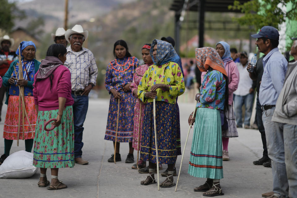 Rarámuri women runners listen to instructions before the start of the Arihueta race in Cuiteco, Mexico, Saturday, May 11, 2024. Nestled in a remote mountain range in northern Mexico, the Tarahumaras, who identify themselves as Rarámuris, got used to running to cope with long distances, scarcity and isolation. (AP Photo/Eduardo Verdugo)