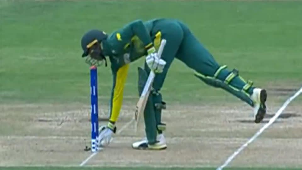 Pillay makes the mistake of picking up the ball. Pic: ICC