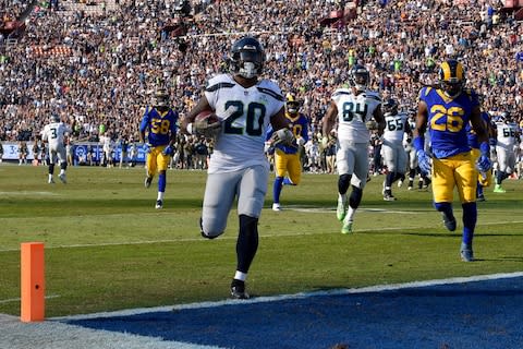 Seattle Seahawks running back Rashaad Penny scores against the Los Angeles Rams during the first half in an NFL football game Sunday - Credit: AP Photo/Mark J. Terrill