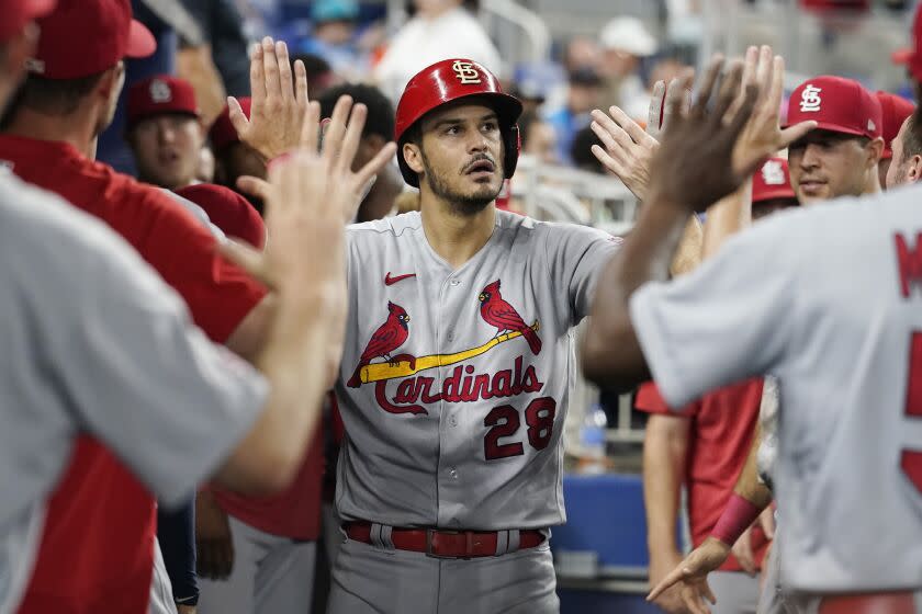 Cardinals third baseman Nolan Arenado is congratulated by his teammates after hitting a solo homer