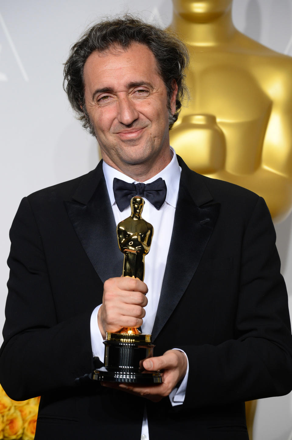 Paolo Sorrentino poses in the press room with the award for best foreign language film of the year for "The Great Beauty" during the Oscars at the Dolby Theatre on Sunday, March 2, 2014, in Los Angeles. (Photo by Jordan Strauss/Invision/AP)