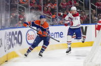 Montreal Canadiens' Evgenii Dadonov (63) and Edmonton Oilers' Tyler Benson (16) battle for the puck during third-period NHL hockey game action in Edmonton, Alberta, Saturday, Dec. 3, 2022. (Jason Franson/The Canadian Press via AP)