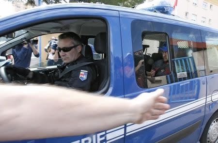 Russian soccer fans, suspected of being involved in clashes, are driven away in a gendarmerie vehicle after being taken off their bus in Mandelieu near Cannes in southern France, June 14, 2016. REUTERS/Eric Gaillard