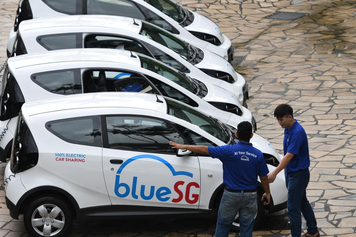 Workers prepare shared electric cars of Singapore's first share electric car company BlueSG during a launch ceremony at the Singapore Flyer on Dec. 12, 2017.(Xinhua/Then Chih Wey via Getty Images)