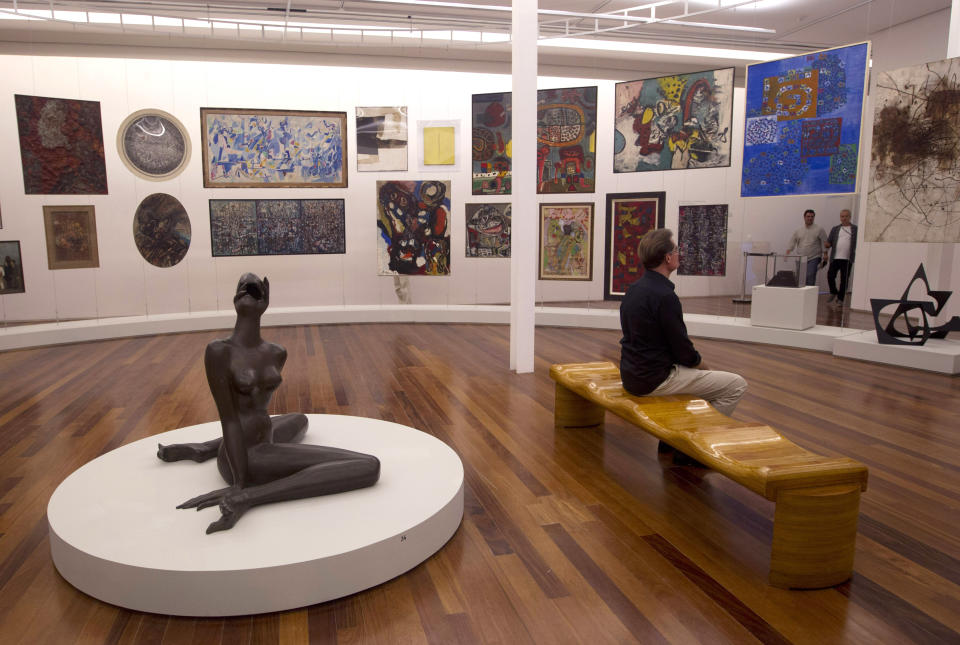 A man looks at a painting in the Rio Art Museum during a media tour before its inauguration in Rio de Janeiro, Brazil, Thursday, Feb. 28, 2013. The museum, scheduled to open on Friday, is part of Rio’s multi-billion dollar bid to reinvent itself before playing host to a double header of mega-events, the 2014 World Cup soccer tournament and the 2016 Olympics. (AP Photo/Silvia Izquierdo)