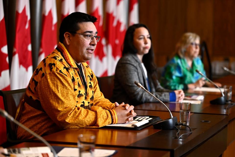 Chief Dylan Whiteduck of Kitigan Zibi Anishinābeg First Nation, left, speaks during a news conference on the opposition to a planned radioactive waste dump near the Ottawa River on June 20, 2023.