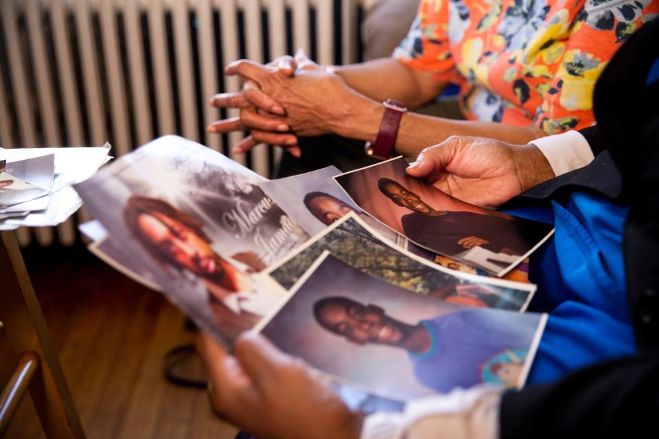 Marilyn Donald and Elvis Ellis, the mother and grandmother of Marcus Donald, look at family photos of Marcus as a child and teenager along with the program from his funeral in Ellis’ home in Memphis, Tenn., on March 20, 2023. Donald died while in custody at Shelby County Jail and another inmate has been charged with his murder. 