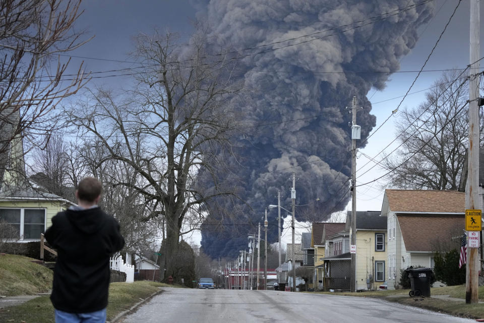 A black plume rises over East Palestine, Ohio, after a controlled detonation of a portion of the derailed Norfolk Southern train (Gene J. Puskar / AP file)