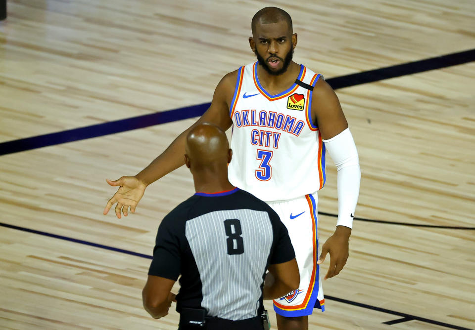 Oklahoma City Thunder's Chris Paul (3) discusses a call with referee Marc Davis (8) during the first half of an NBA basketball game against the Oklahoma City Thunder' Wednesday, Aug. 5, 2020, in Lake Buena Vista, Fla. (Kevin C. Cox/Pool Photo via AP)