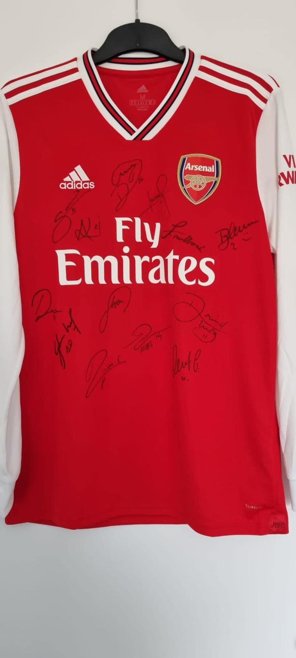 An Arsenal shirt signed by the men’s first team gifted to Mr Cain wishing him a good recovery (Supplied)