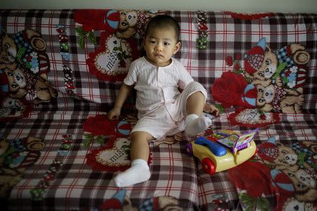 Huang Aiting, who was born in 2013, poses for a photograph in Shanghai July 26, 2014. REUTERS/Carlos Barria